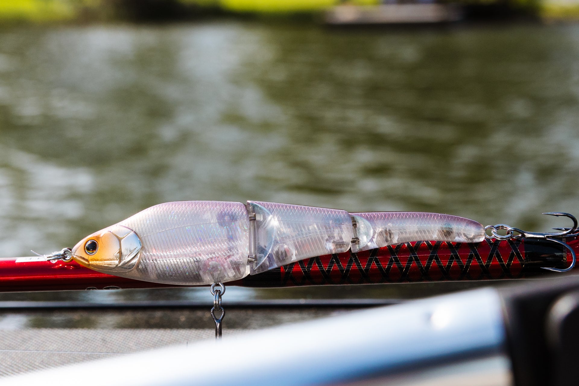 A close up of Magic Swimmer® Freshwater bait on the deck of a boat next to a fishing rod