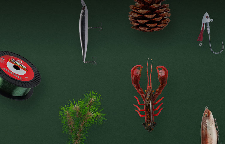 The flat lay features fishing gear such as lures, hooks, and tackle, surrounded by holiday decorations like holly and bells and red and green accents.
