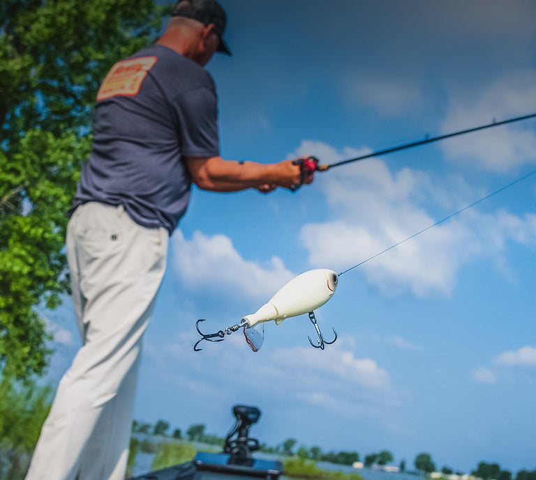 Man fishing with a large white lure on a clear day