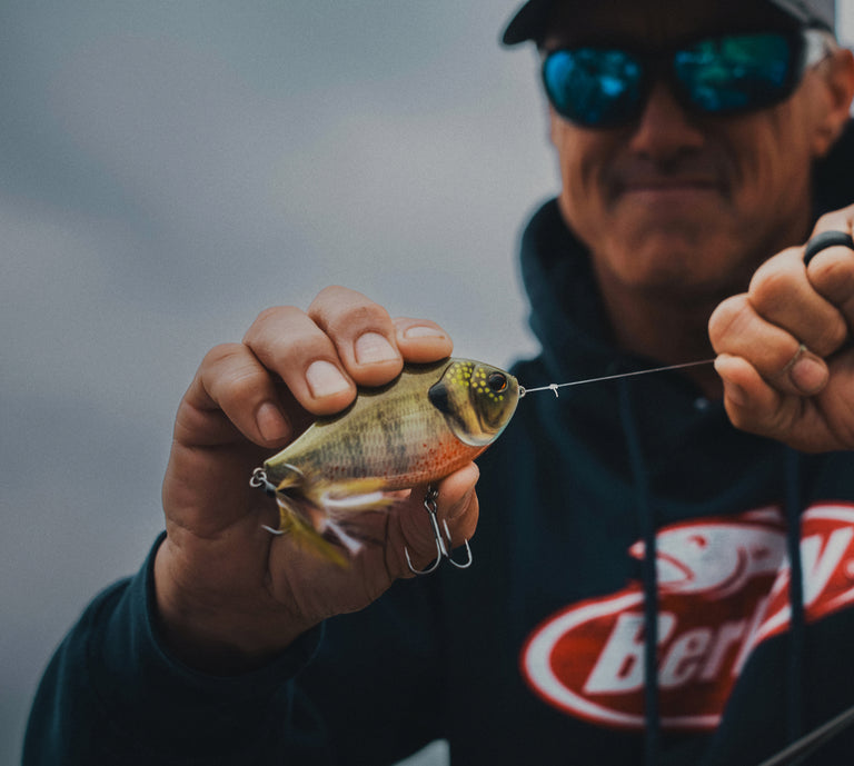 close up of berkley slapgill bait in a fishermans hands