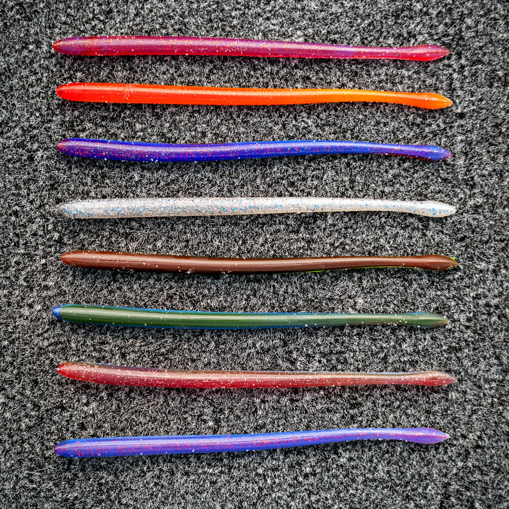 Set of colorful fishing lures on a dark surface