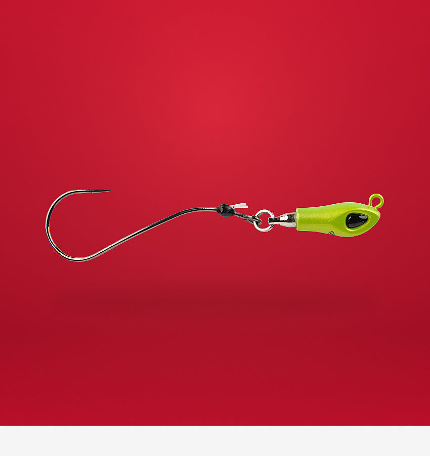 Fishing lure with a green body and black hook on a red background