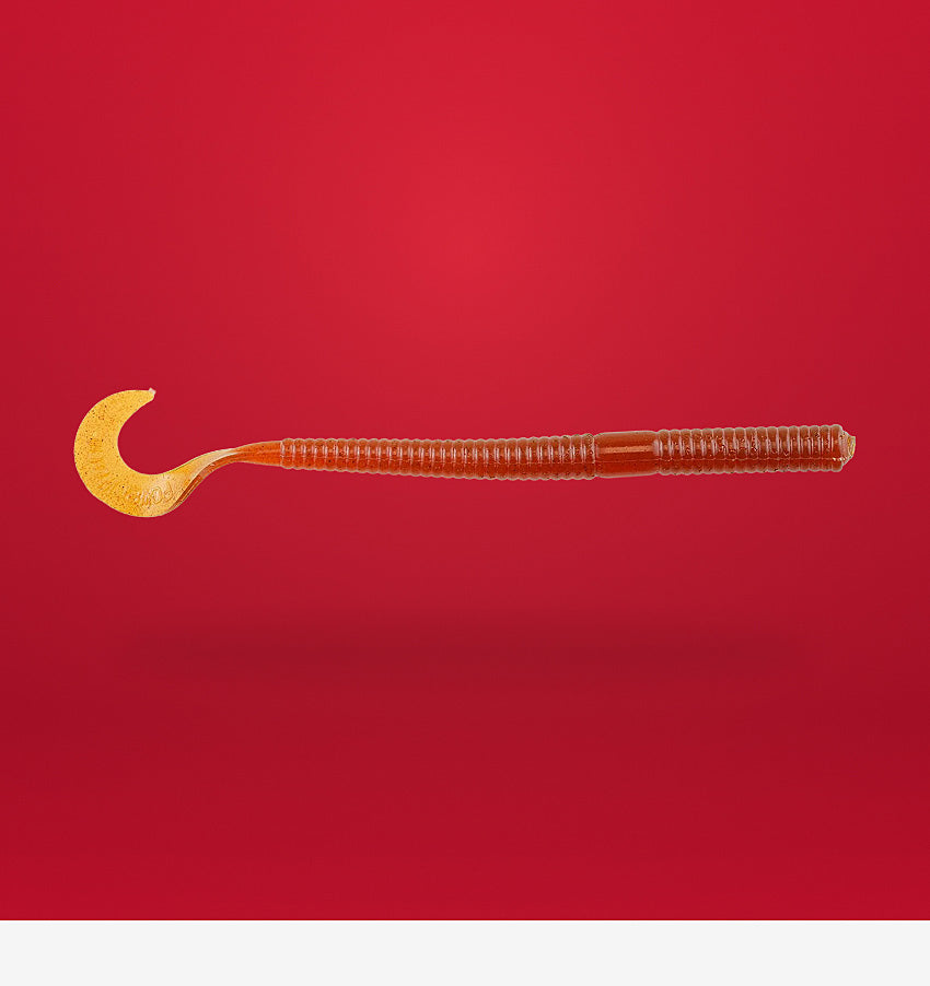 Transparent fishing lure with a hook on a red background